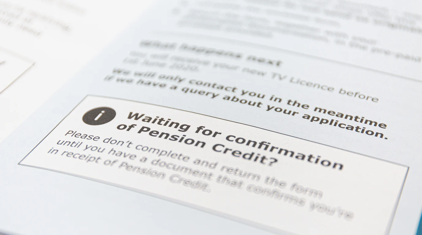 An angled close-up of a printed letter, a boxed notice with an information icon standing out from the surrounding small print.